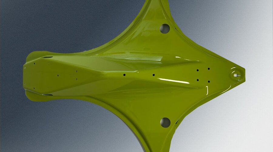 A painted green cover hood for an agricultural machine, featuring an aerodynamic shape and precisely designed cutouts for mounting and functionality.