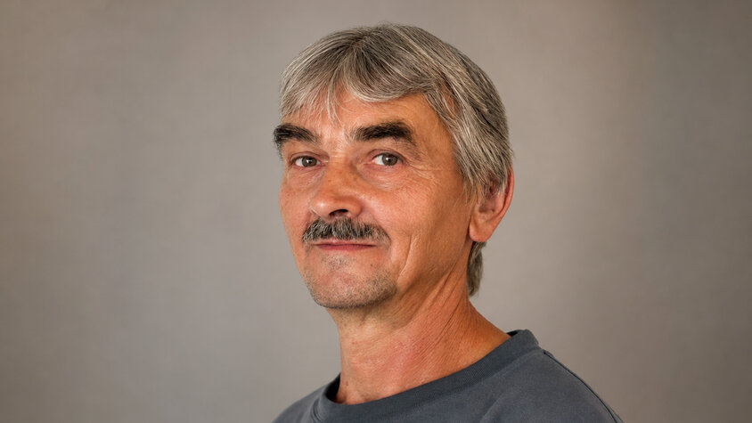 Professionelles Porträt von František Krumpolec vor einem dezent grauen Studiohintergrund.
