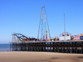 Seaside amusement park in Blackpool, England, with roller coaster and attractions